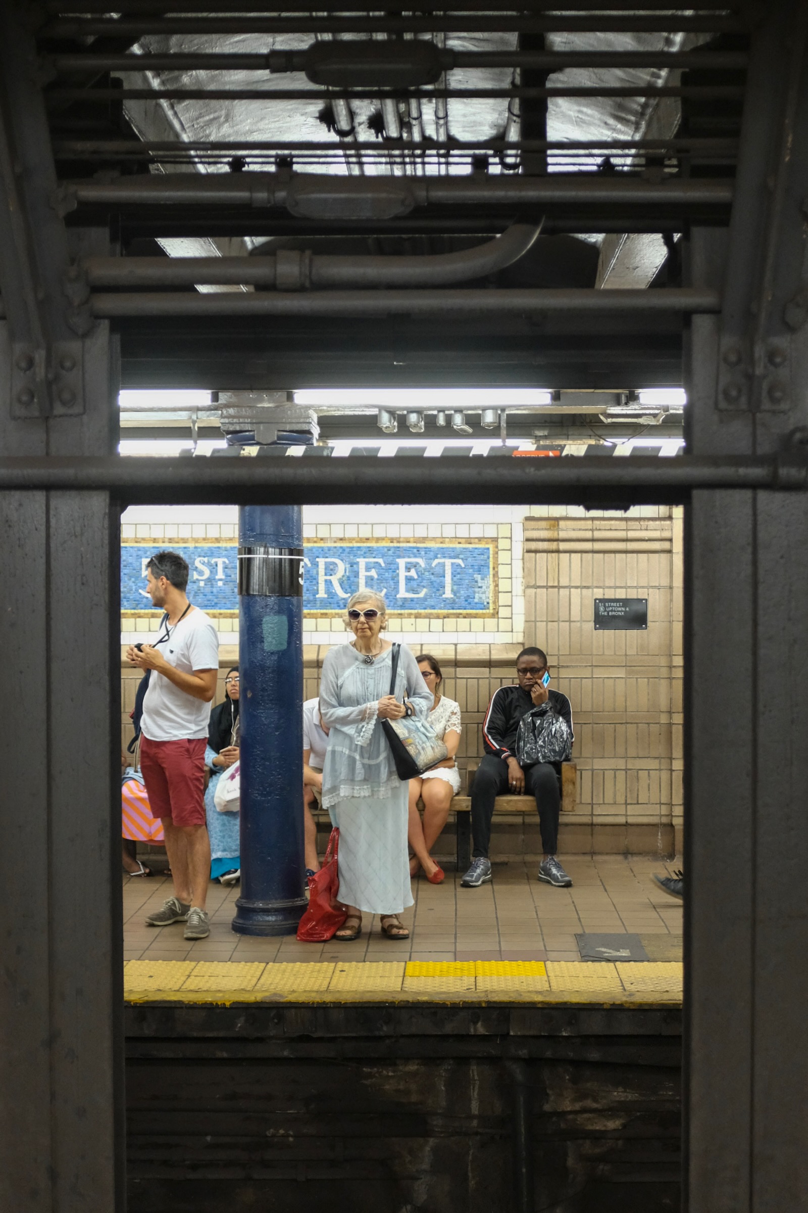 Atmospheric candid photograph inside a bustling New York City subway car transit corridor