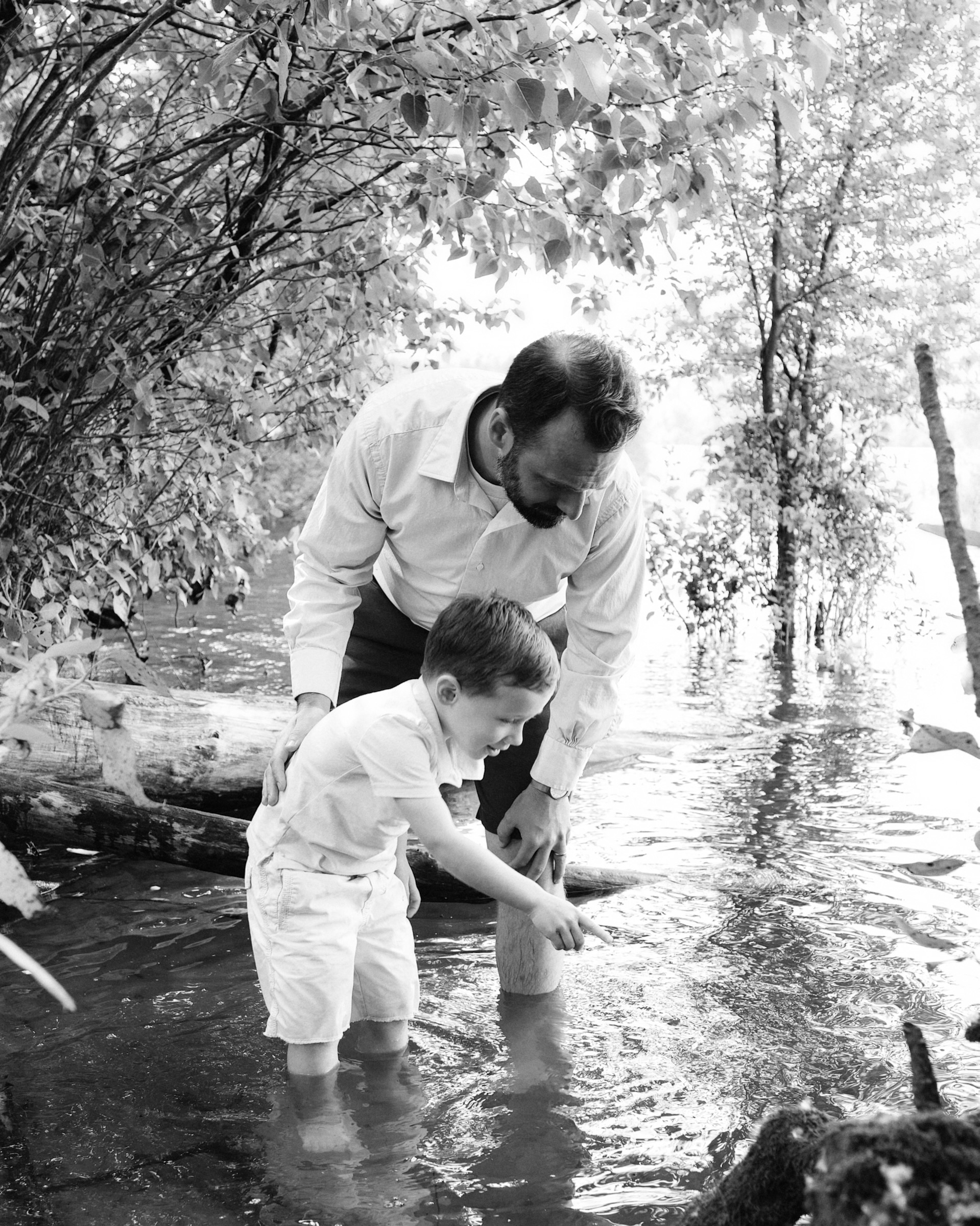 Father and son wading together in the water in Washougal Washington